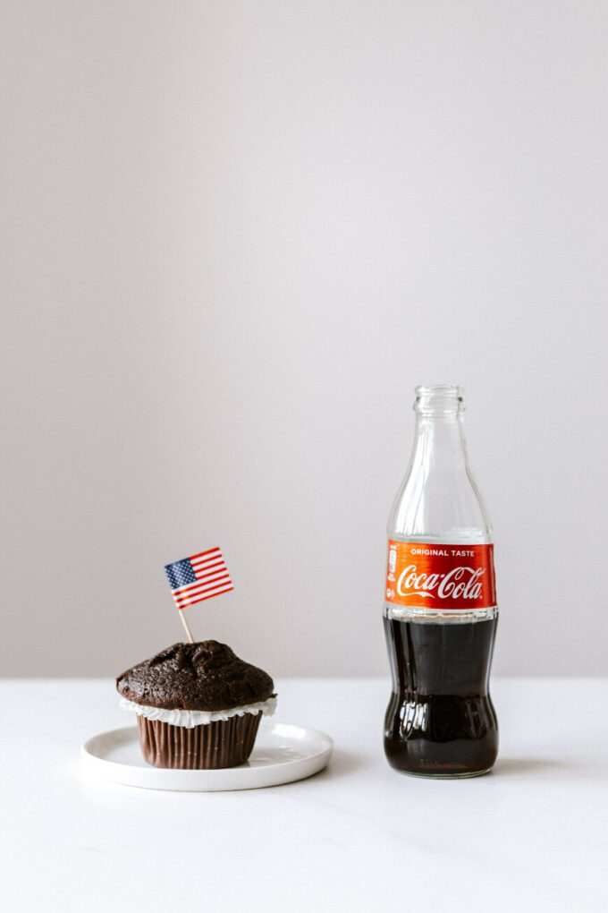 coca cola bottle and chocolate muffin