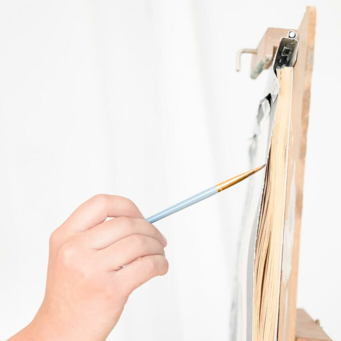 person painting on an easel