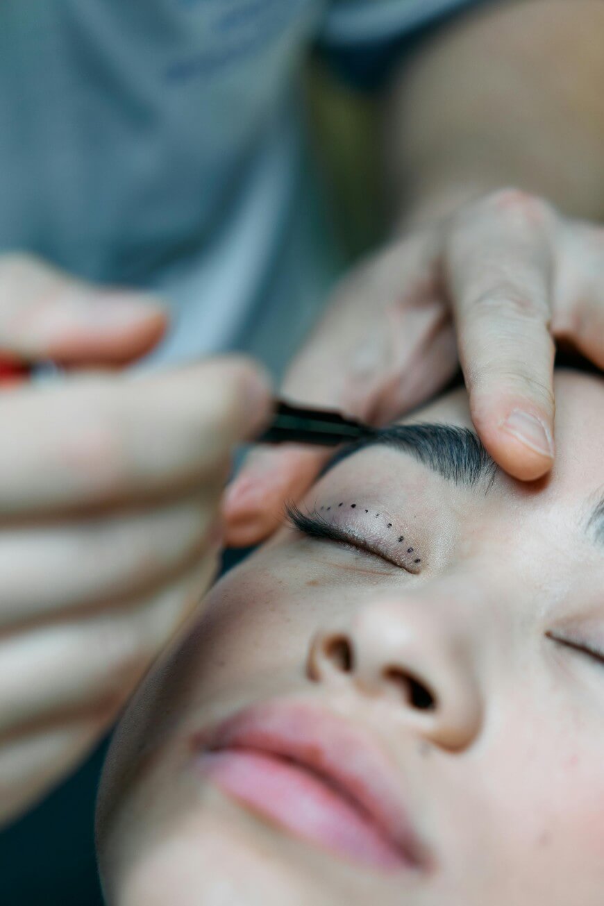 surgeon marking woman's face