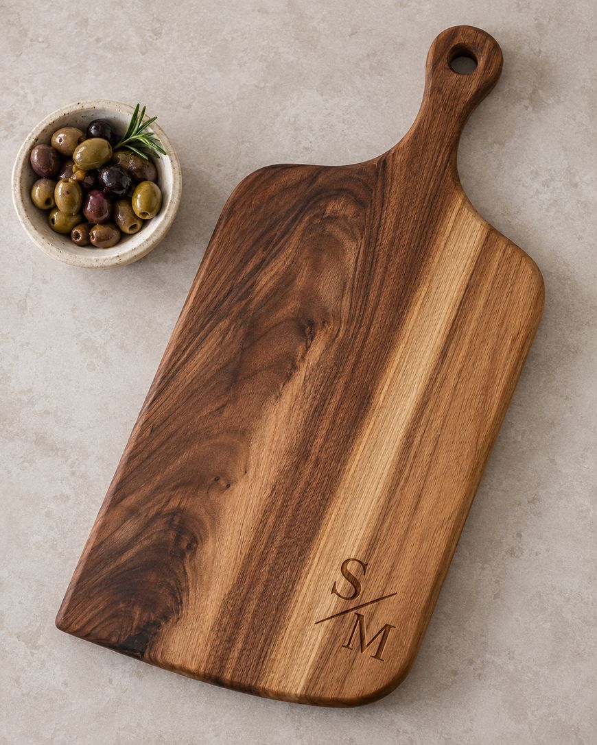 A dark walnut cutting board on a pale surface.
